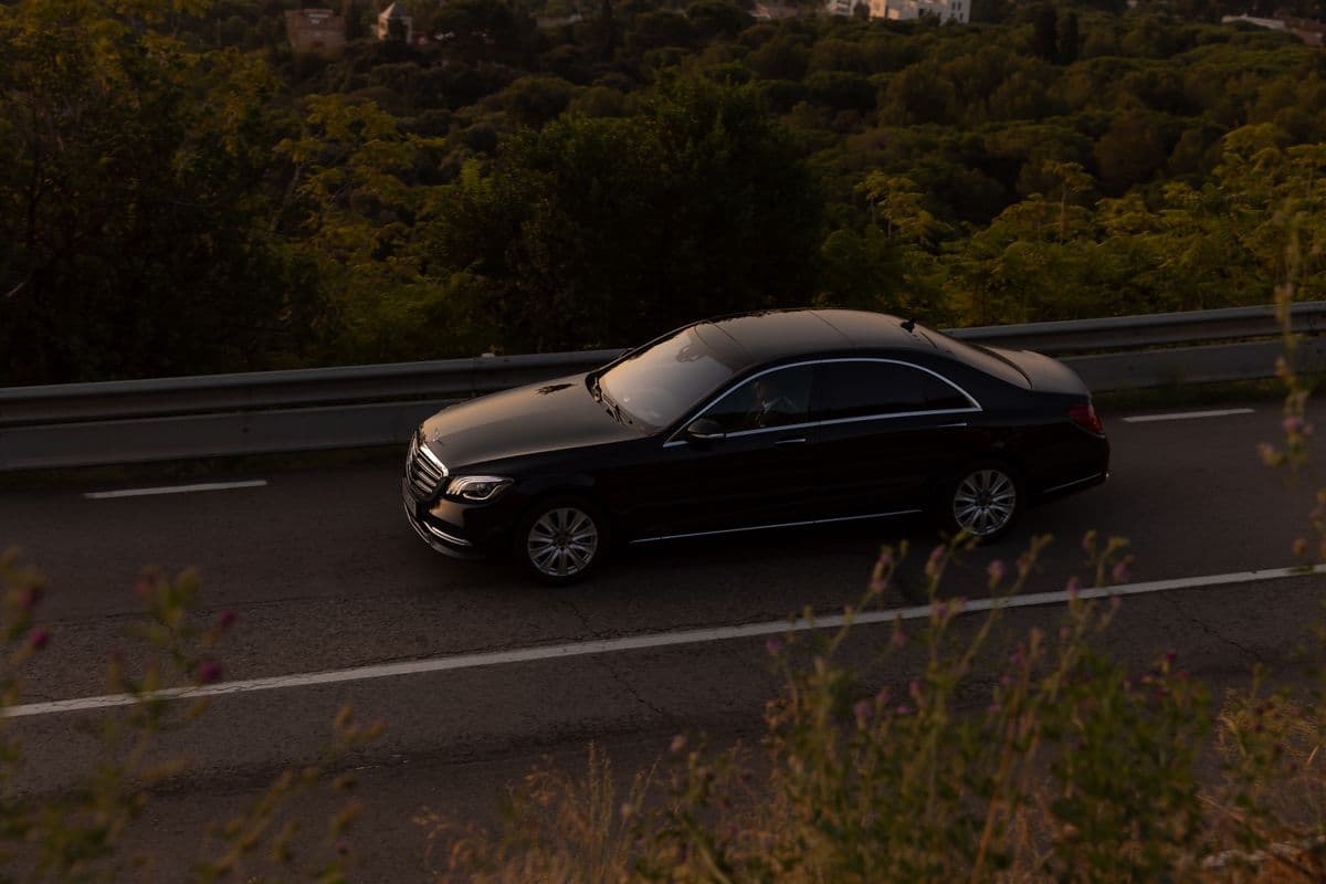 Luxury sedan at dusk on a coastal road